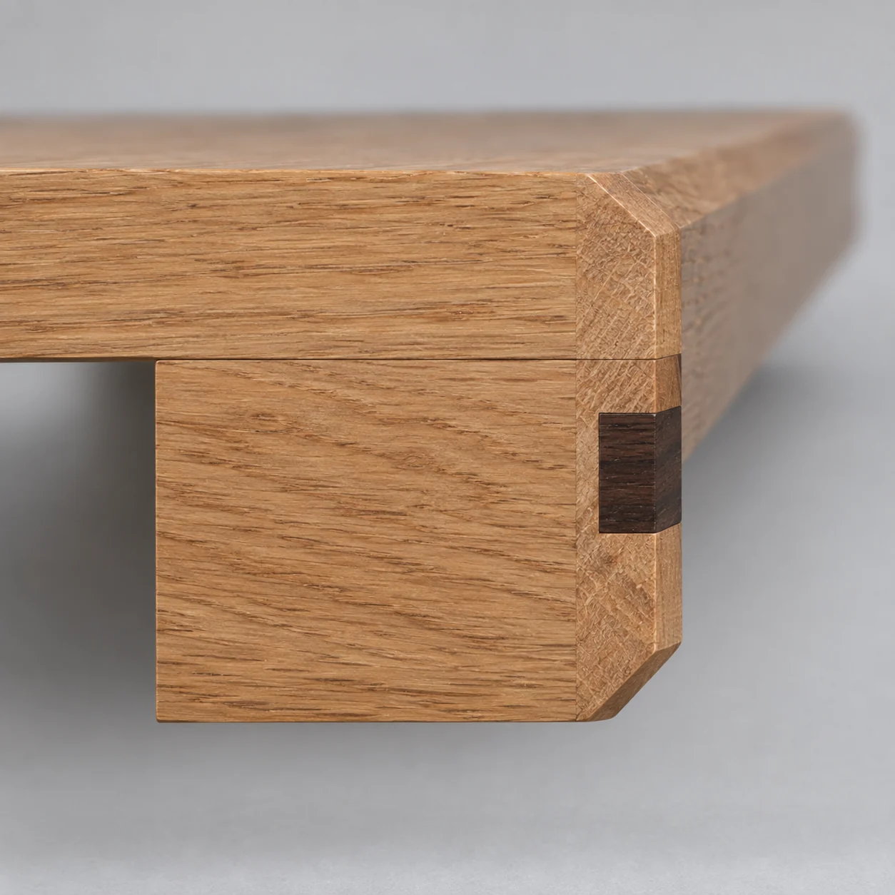 End of an inlay window sill showing the slab, the built-up front edge, the bevels and the inlay band in section